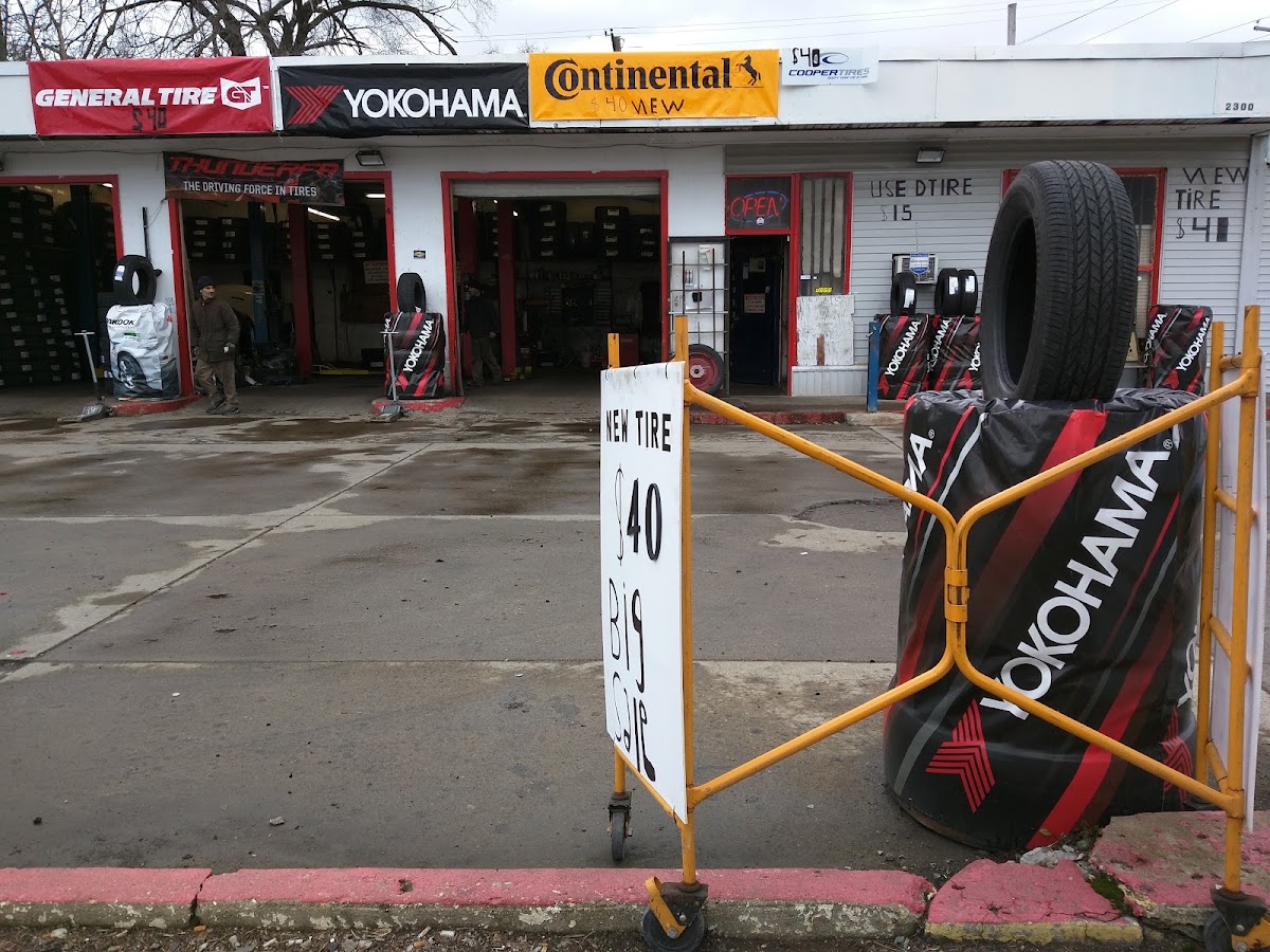 BB Hudson Tires storefront on Cleveland Ave, with hand-lettered price signs and tire brand banners