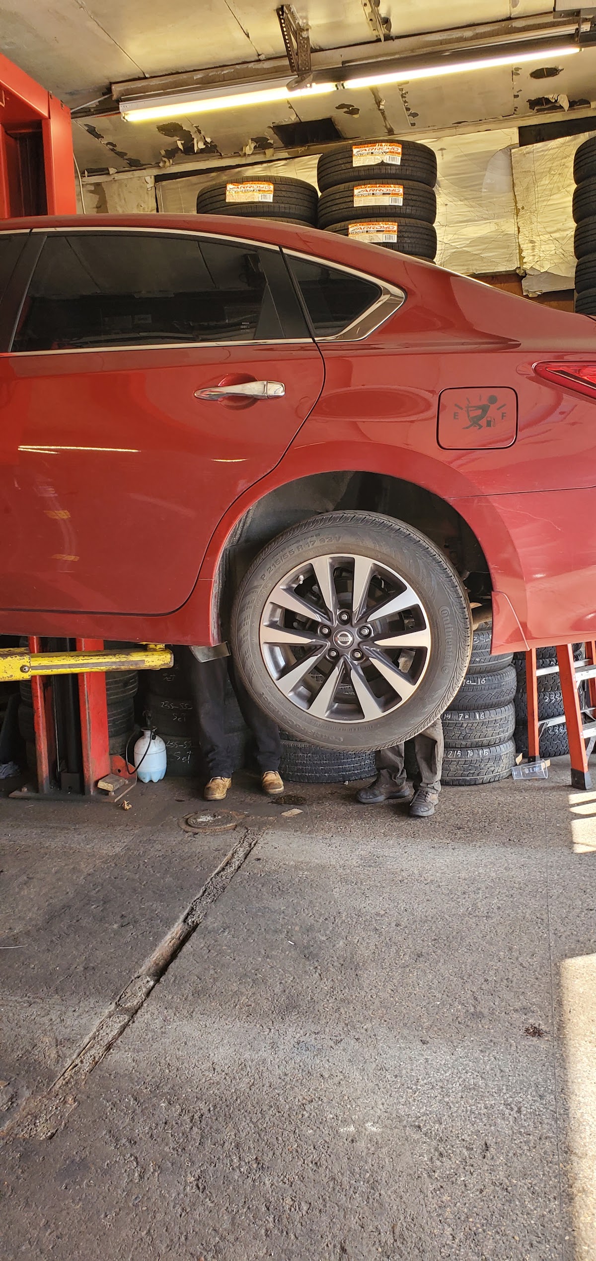 A car up on the lift mid-service at BB Hudson Tires